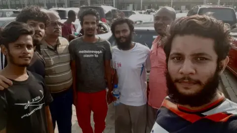 BBC The sailors pictured in Nigeria soon after their release