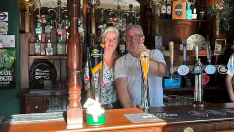 Paul Moss behind the bar of the New Crown with landlady Desiree