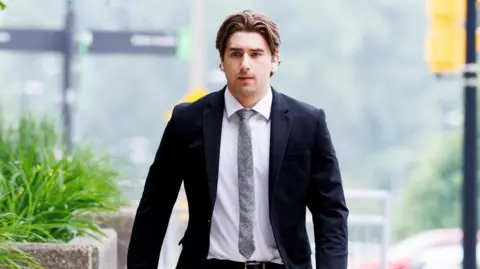 Michael McLeod arrives at court as the defence begins closing arguments in the trial against five teammates on Canada's 2018 gold medal-winning world junior hockey team, charged with sexually assaulting a woman in a hotel room, at the Superior Court of Justice in London, Ontario.