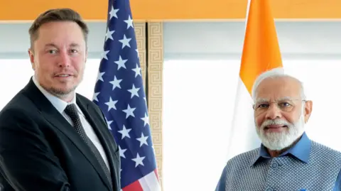 Getty Images Elon Musk meets Narendra Modi in June.
