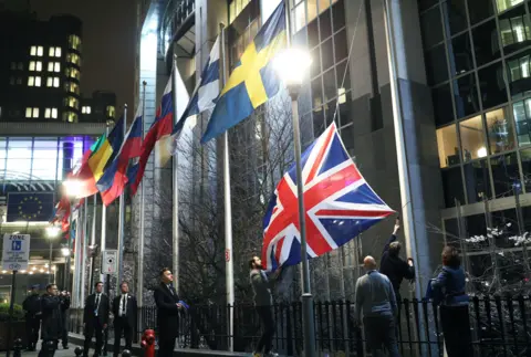 Yui Mok / PA Media The union jack being taken down outside the European Parliament in Brussels