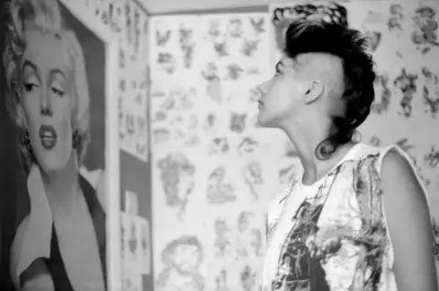 Gavin Watson Kelly looking at poster of Marilyn Monroe