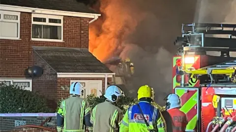 Firefighters tackle the fire