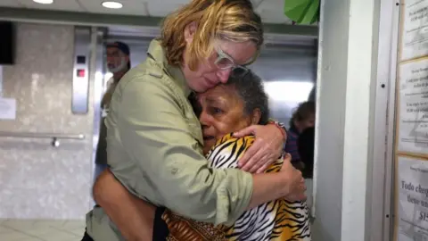 EPA Puerto Rico's mayor holds an upset elderly woman after Hurricane Maria