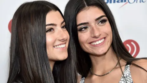 Getty Images Charli D'Amelio (left) with her sister, Dixie