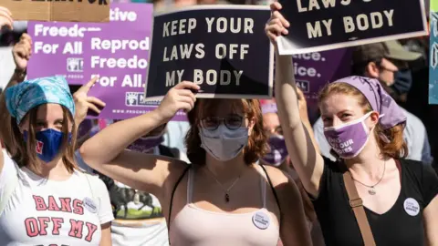 Getty Images Women's rights activists in Washington D.C protesting against the new abortion bill.