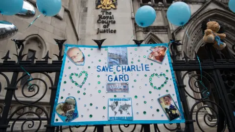 Getty Images Photo tributes outside the Royal Courts of Justice