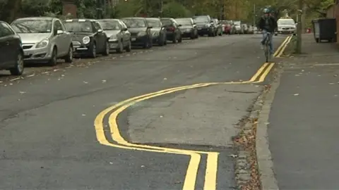 Yellow lines painted round car