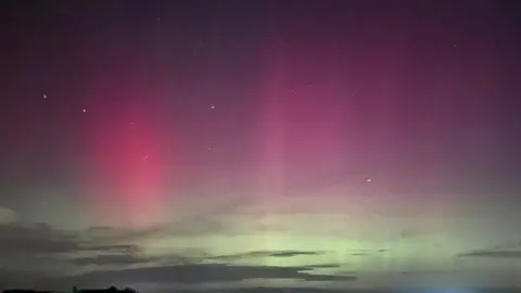 Girl-in-a-field/BBC Weather Watchers Northern Lights near Wymondham