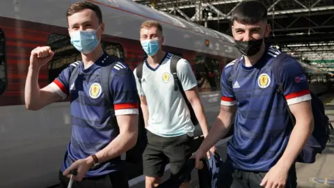 PA Media fans at Edinburgh Waverley station on Friday