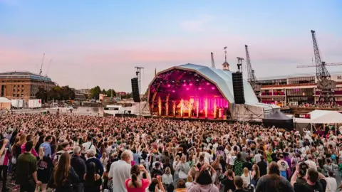 Ania Shrimpton Crowds in front of a concert stage