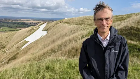 BBC MP Andrew Murrison standing close to the White Horse