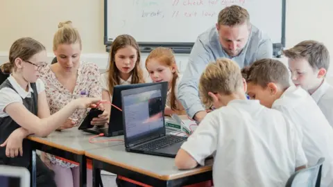 Getty Images Teacher taking a lesson with laptops