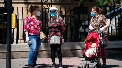 Reuters People wearing face masks in London