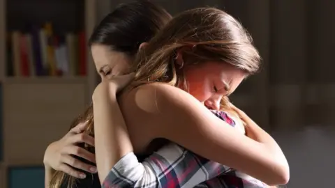 Getty Images Mother and daughter embracing