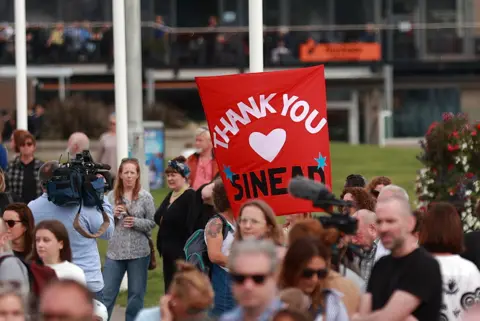 PA Media Mourners pay tribute to Sinéad O'Connor in Bray on 8 August 2023