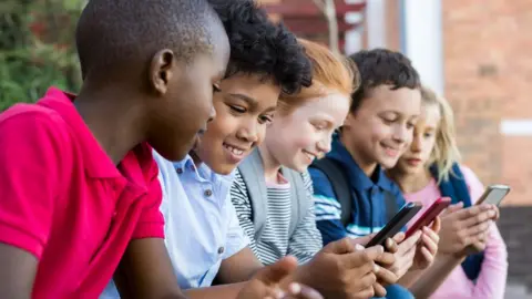 Getty Images Children using mobile phones