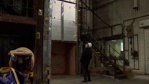 Fire test rig used at the BRE, with reporter for scale