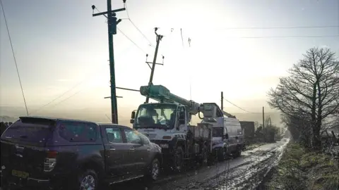 Getty Images Power cables being repaired after damage caused by Storm Arwen