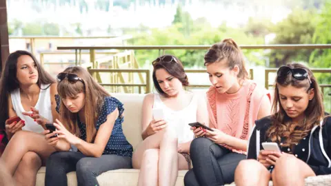 Getty Images Girls on phones