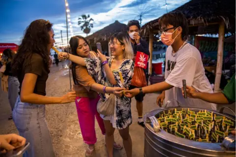 Getty Images Thai people buy cannabis popsicles at a marijuana legalization festival on June 11, 2022 in Nakhon Pathom, Thailand.