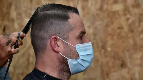 Pacemaker Man gets haircut while wearing face mask