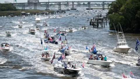 Getty Images Dozens of boats take part in a Make America Great Again parade off Charleston, South Carolina. Photo: 24 may 2020