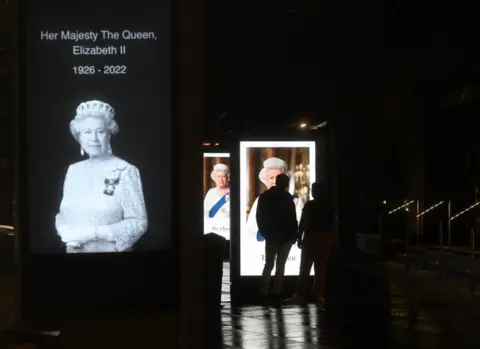 Getty Images Digital advertising boards at bus stops displayed pictures of the Queen