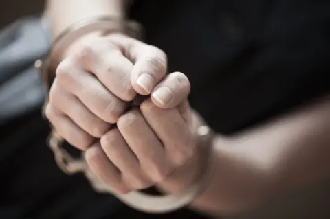 Getty Images Woman in handcuffs