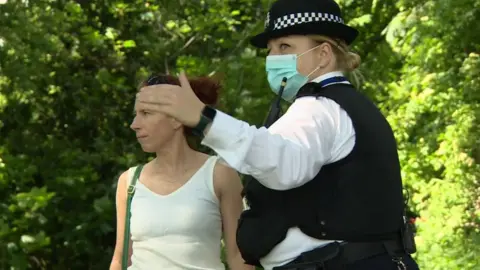 Police officer talking to a woman in Brockwell Park