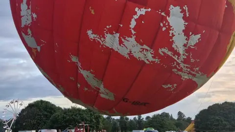 Dan Whitelock/Bristol Balloon Collectors BBC globe balloon lifting off into the sky