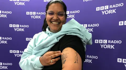 Former York student Tanisha Jain showing off her duck tattoo 