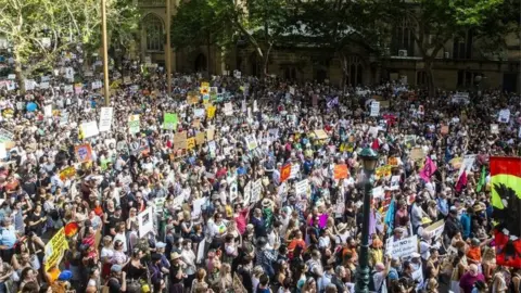 Getty Images Activists rally for climate action at Sydney Town Hall on January 10, 2020 in Sydney, Australia.