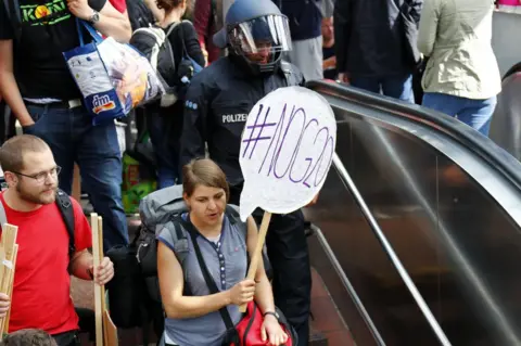 Reuters Activists arrive at Hamburg central railway station, 6 July