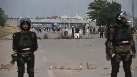 AFP Pakistani rangers stand guard as protesters block a road in Islamabad on November 27, 2017.