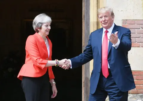 Getty Images Donald Trump and Theresa May shaking hands outside Chequers