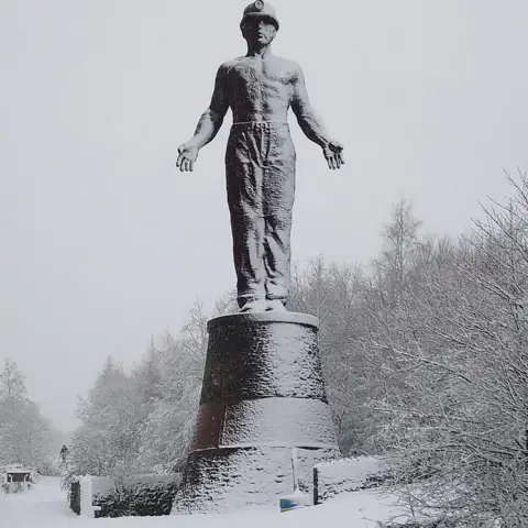 Saul Somerville Snow settles on the Guardian of the former Six Bells colliery site, near Abertillery in Blaenau Gwent.