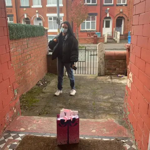 Anoushka Mutanda Dougherty Lily, in isolation, collecting a birthday present