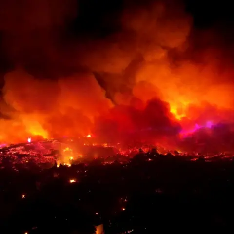 Ted G Bailos/Reuters Wildfires burn through night on island of Rhodes