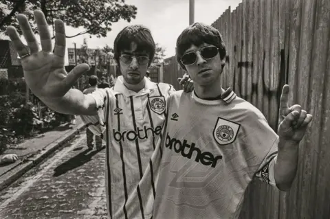 Kevin Cummins Liam and Noel Gallagher wearing Manchester City football shirts