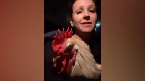 Jessica Matthews holding a cockerel