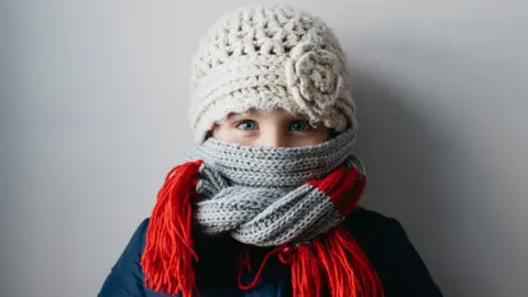 Getty Images Child in layers of clothes