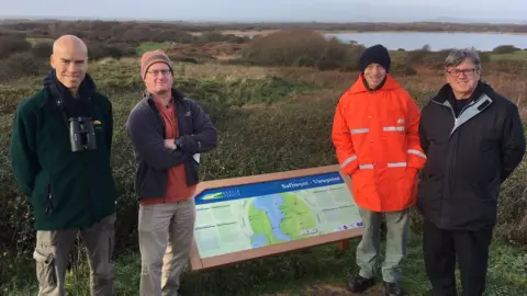 Bridgend County Borough Council Reserve manager Dave Carrington, council officer Mark Blackmore, volunteer warden Robert Howells and cabinet member Charles Smith at Kenfig