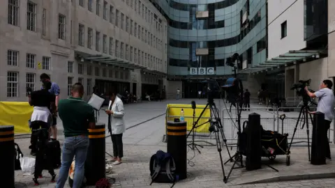 Reuters Members of the media outside BBC's New Broadcasting House on Monday, 10 July