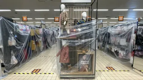 Getty Images Clothes rails covered in cellophane in Sainsburys in Cardiff