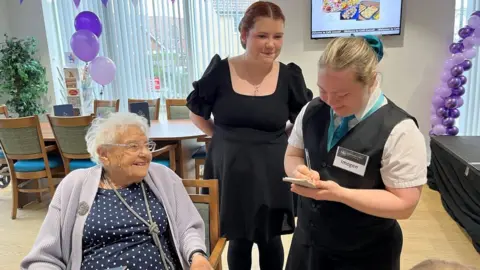 Shaun Whitmore/BBC Staff serving a woman at Cafe Cornell in Saffron Walden