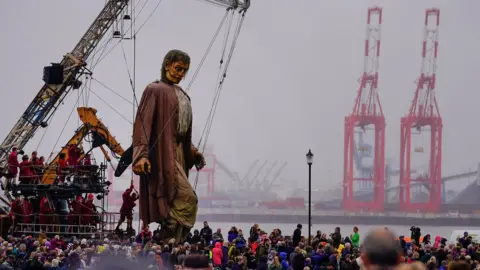 Getty Images Giant Man walks along the promenade at New Brighton