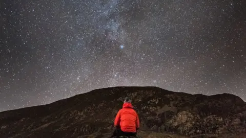 Lee Evans Lee Evans sent this stunning image of Snowdonia at night for our picture of the day.