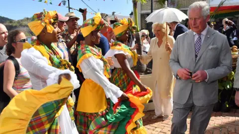 Getty Images Prince Charles and Camilla visit a market during their visit to Grenada