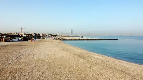 MAHMOUD KHALED / EPA A picture taken with a drone shows an empty beach closed to visitors, in Dubai, United Arab Emirates